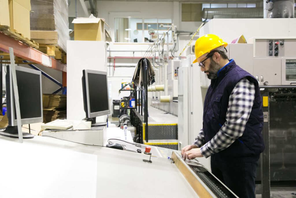 focused male engineer glasses operating machine