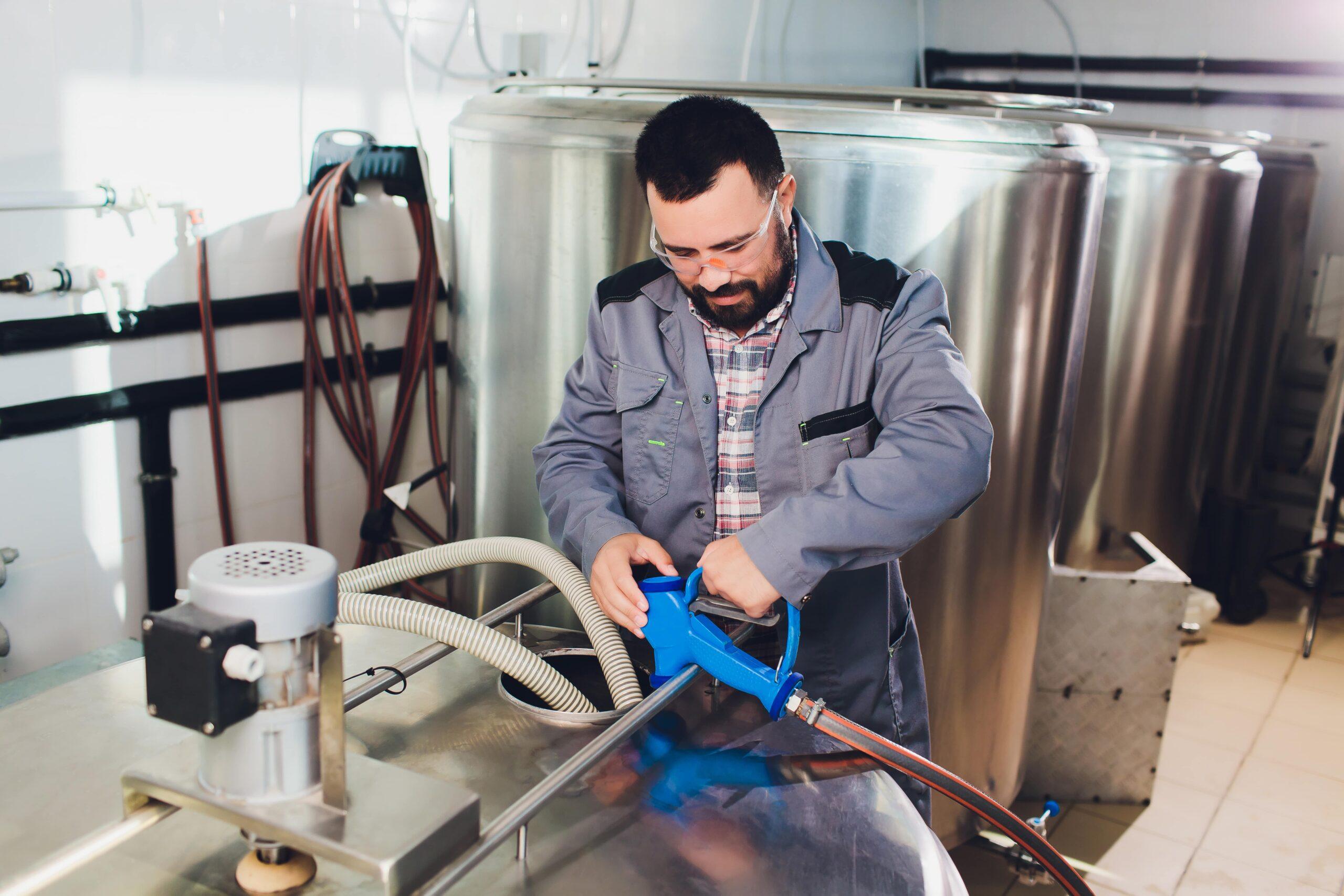 portrait brewer who is making beer his workplace brew house 1 min scaled